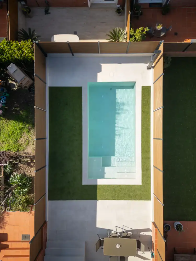 Vista aerea de piscina y pavimentos dentro de una reforma exterior