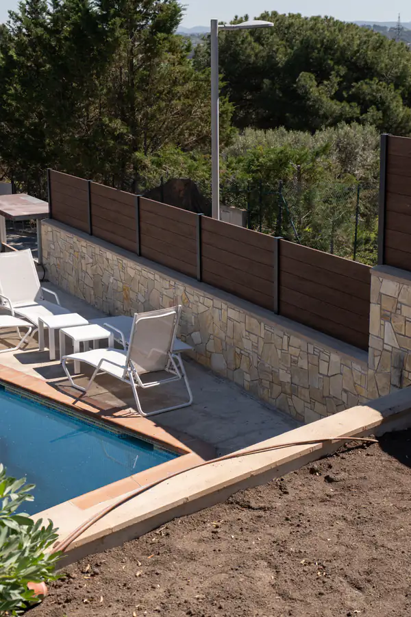 Valla de aluminio efecto madera Turner Oak instalada sobre muro